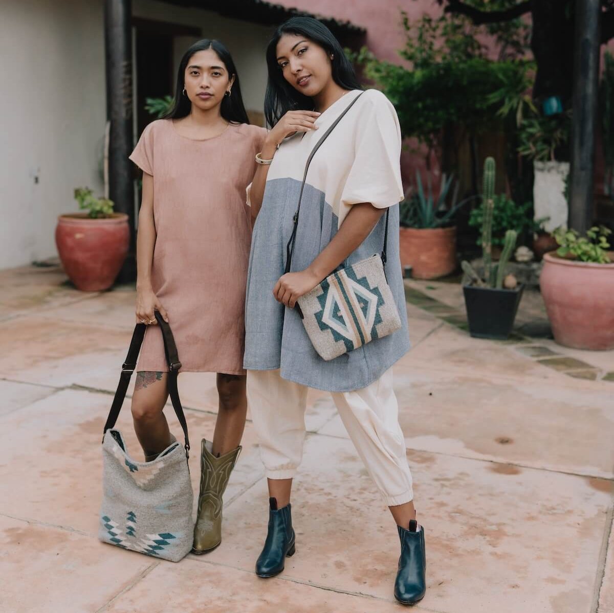 Woman wearing an AMASOUK Sueños Crossbody bag, showcasing dark brown leather strap and handwoven wool in blue, heather gray, and ivory with traditional Zapotec patterns. Perfect for versatile styling.