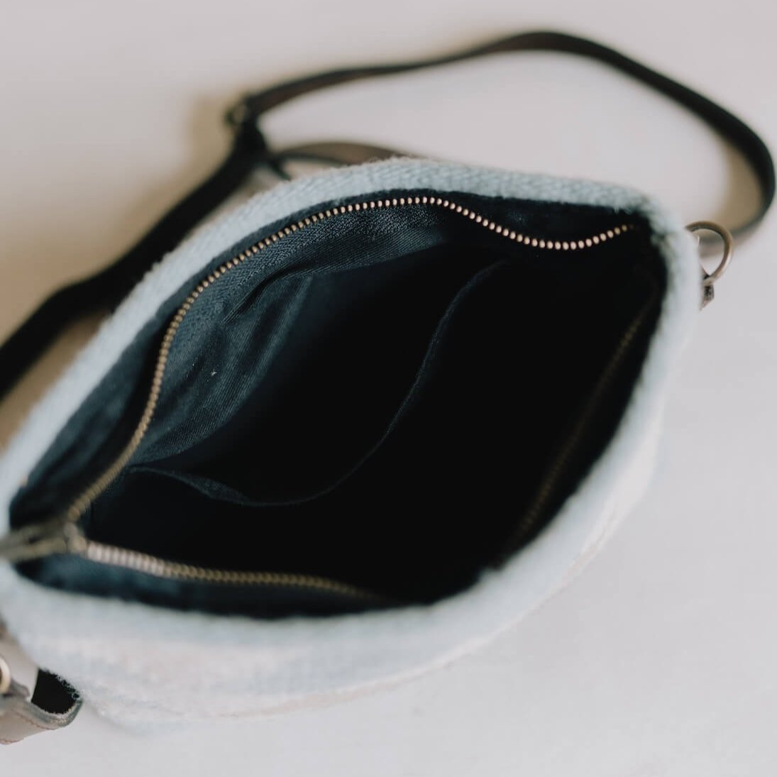 Interior of AMASOUK handwoven wool Reflejos convertible clutch/wristlet/crossbody bag, featuring a Zapotec pattern in stunning shades of blue. A versatile 3-in-1 accessory for any occasion.