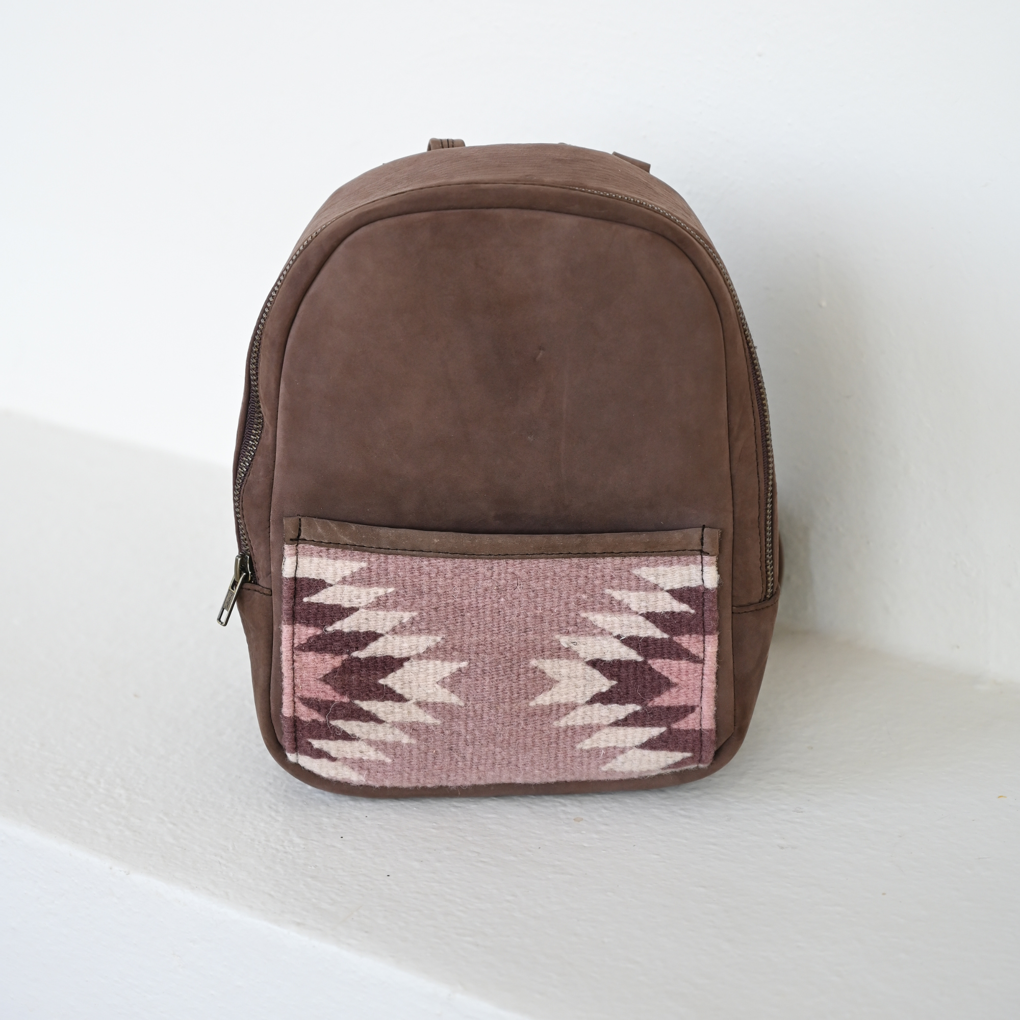 AMASOUK Aguila Mini Backpack in brown leather and sand and purple wool. Handcrafted with a combination of durable leather and soft wool, perfect for stylish and functional everyday use.
