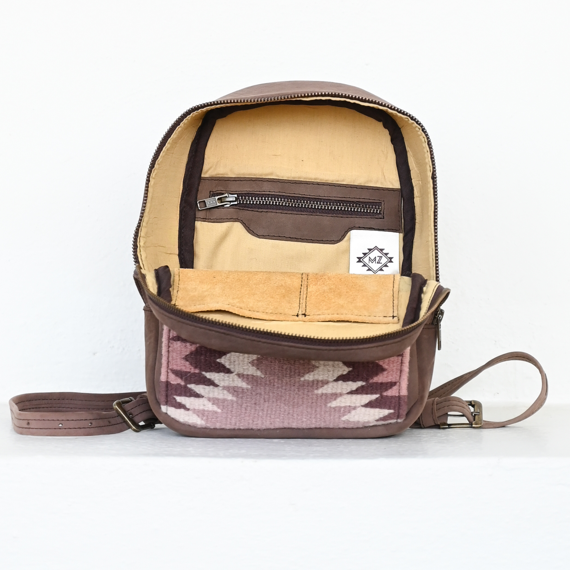 Interior view of AMASOUK Aguila Mini Backpack in brown leather and sand and purple wool. Handcrafted with a combination of durable leather and soft wool, perfect for stylish and functional everyday use.