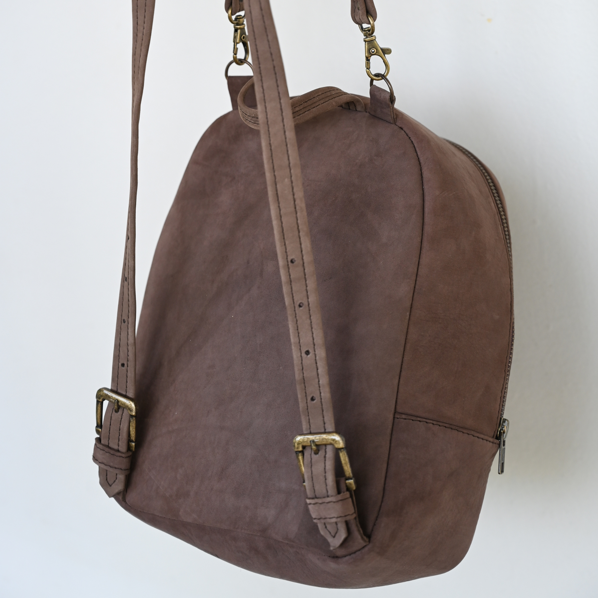 Back view of AMASOUK Aguila Mini Backpack with a unique combination of brown leather and sand and purple wool. A stylish and functional accessory for any occasion.