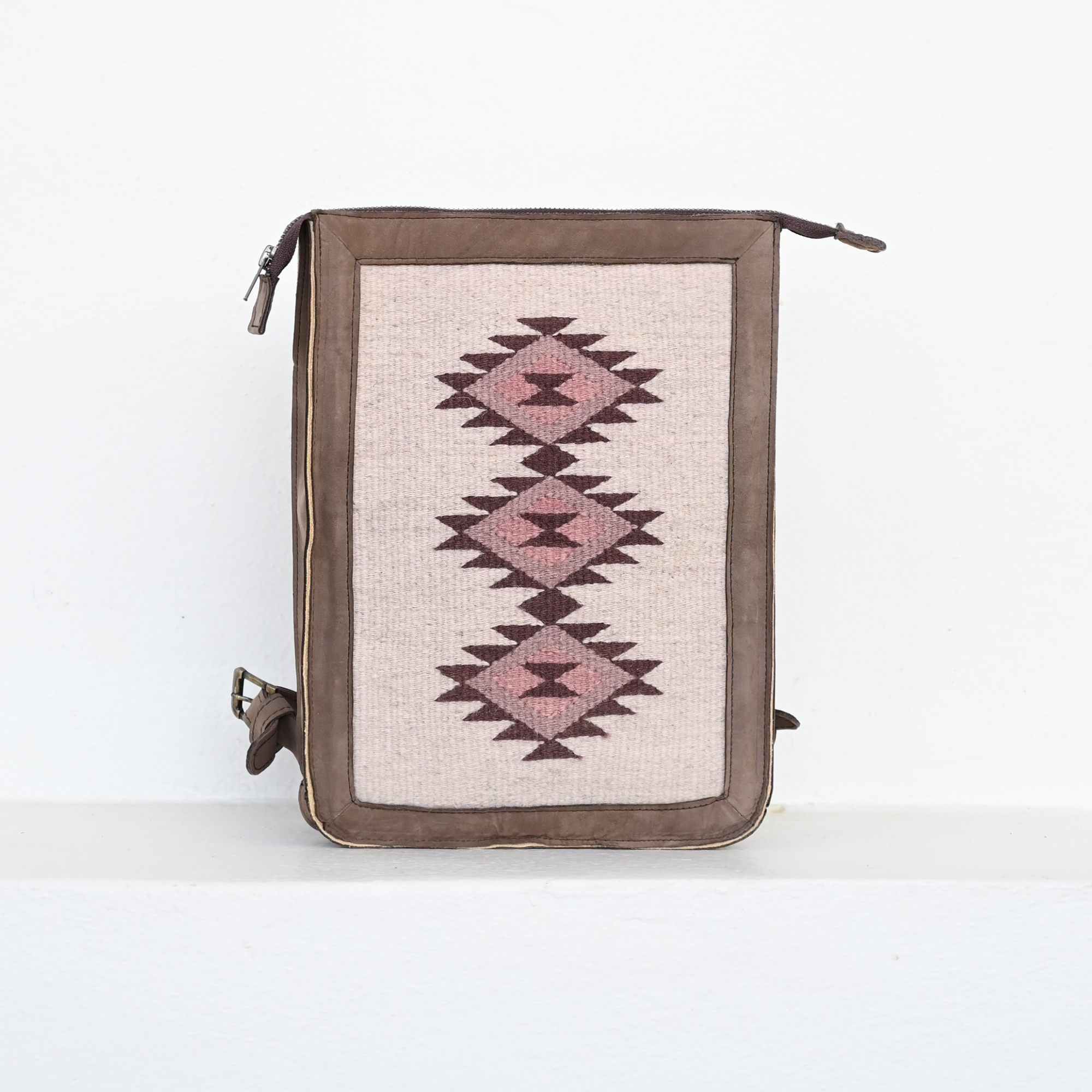 AMASOUK Mora Slim Backpack, crafted from dark brown leather and wool in cream and rosy hues. Perfect for daily errands or a casual day out. Zapotec pattern.