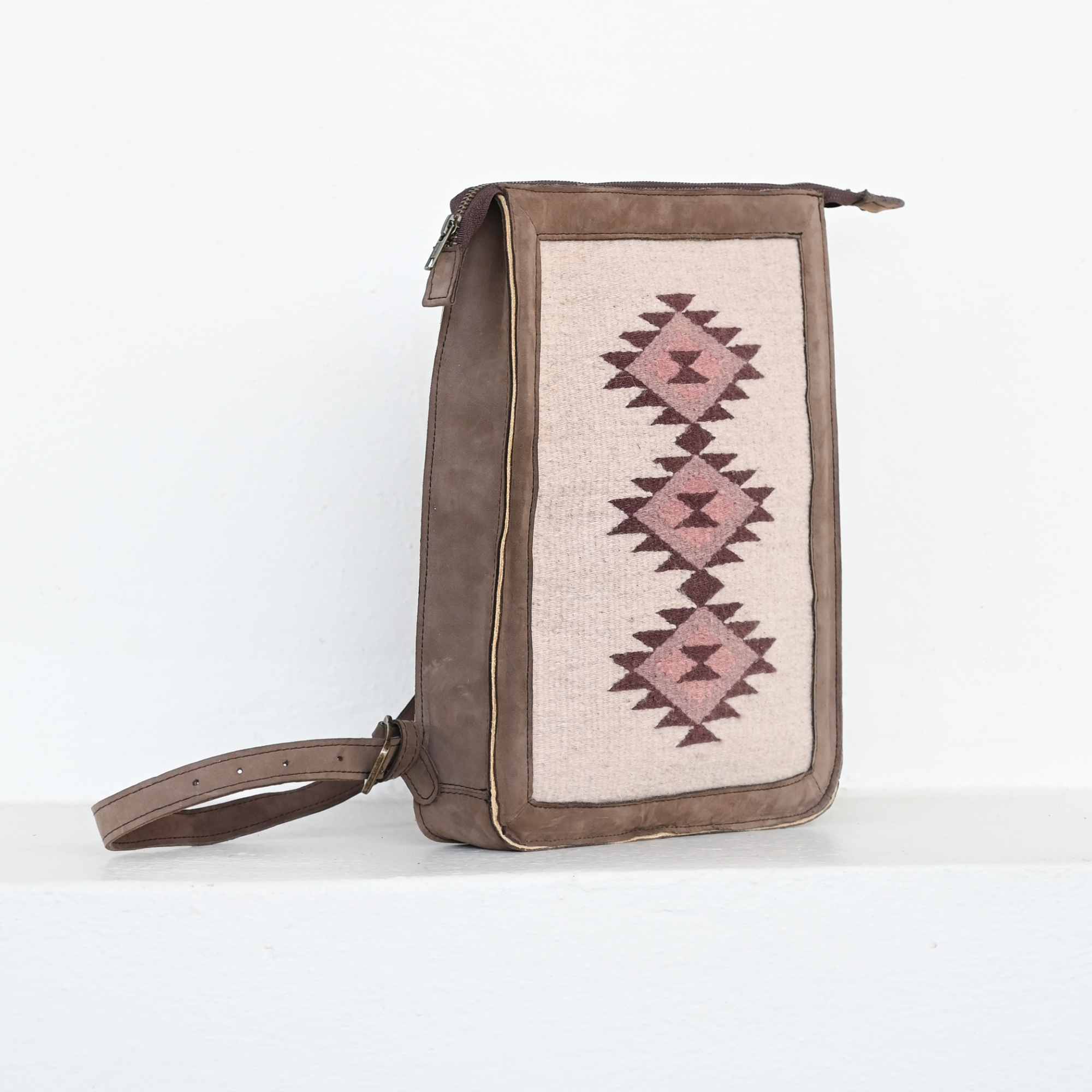 AMASOUK Mora Slim Backpack, crafted from dark brown leather and wool in cream and rosy hues. Perfect for daily errands or a casual day out. Zapotec pattern.