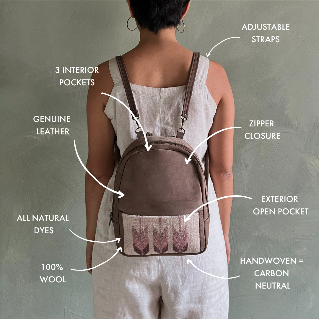 Chic woman carrying the AMASOUK Raiz Mini Backpack, featuring brown leather and handwoven wool in burgundy and cream with a Zapotec design. Ideal for stylish, on-the-go days.