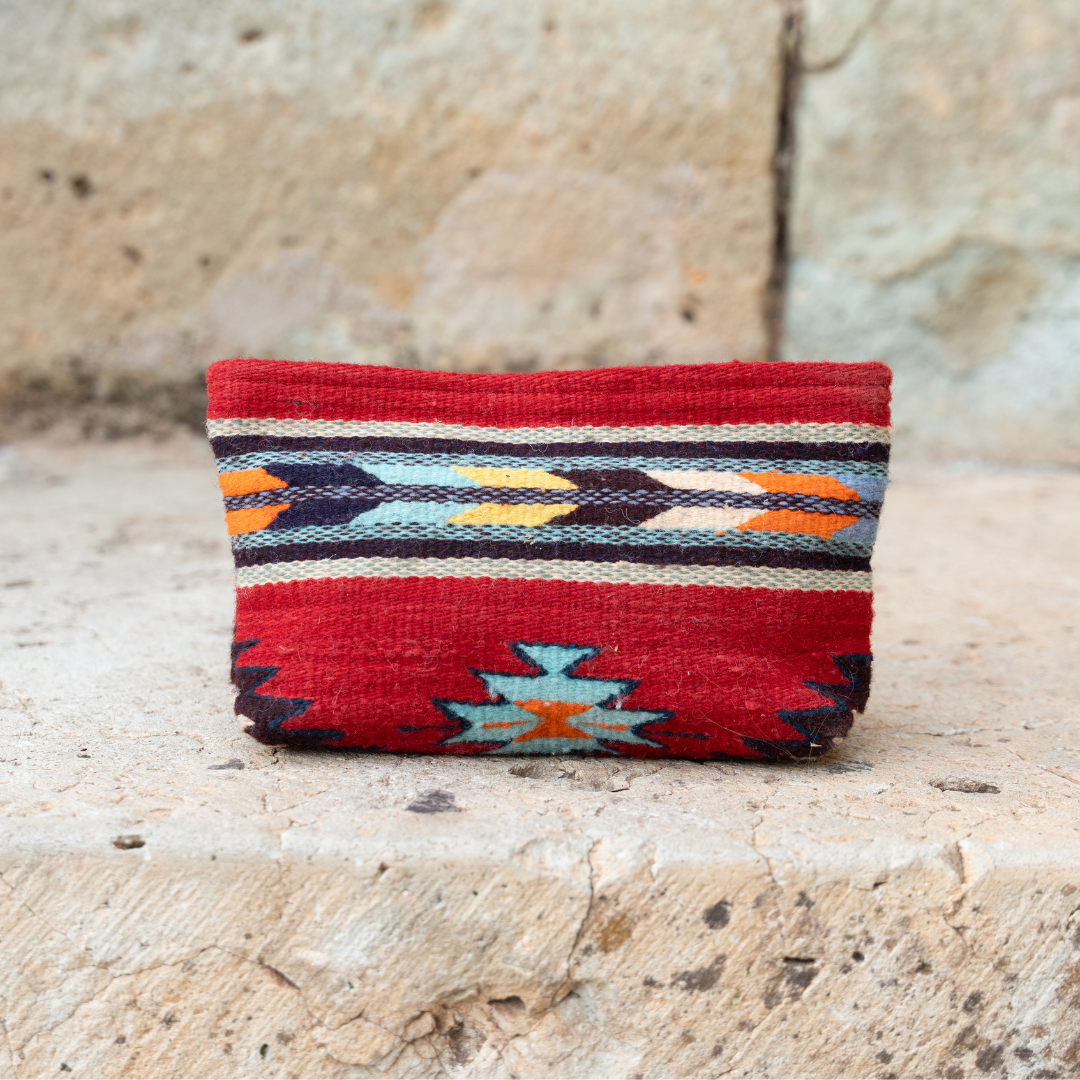 Handwoven pouch with abstract Zapotec arrow design in bold colors featuring internal pocket; perfect for makeup, wallet, or daily essentials.
