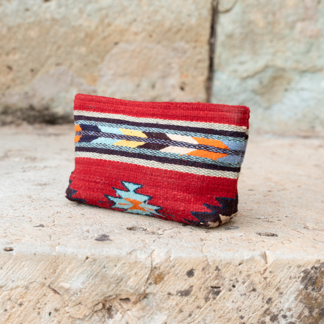 Handwoven pouch with abstract Zapotec arrow design in bold colors featuring internal pocket; perfect for makeup, wallet, or daily essentials.