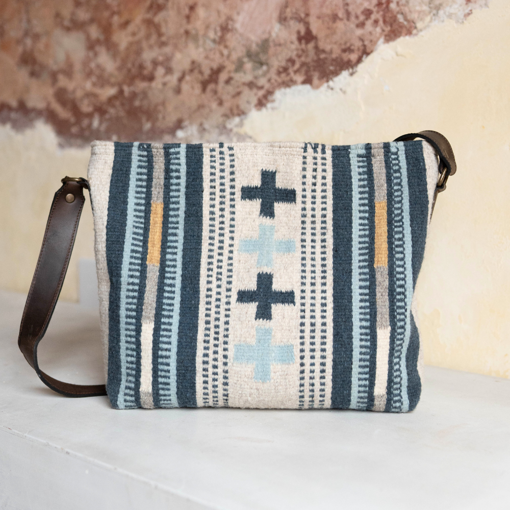 AMASOUK Copalita convertible shoulder/crossbody bag, crafted from handwoven wool and leather in a blue, cream, and honey color scheme. Stylish and versatile for any occasion.