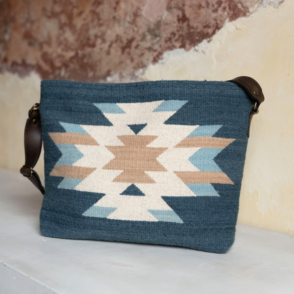 AMASOUK handwoven wool Solyagaua convertible shoulder/crossbody bag in shades of deep ocean blue, soft ivory, and warm honey. Featuring a unique Zapotec pattern, perfect for day-to-night style.