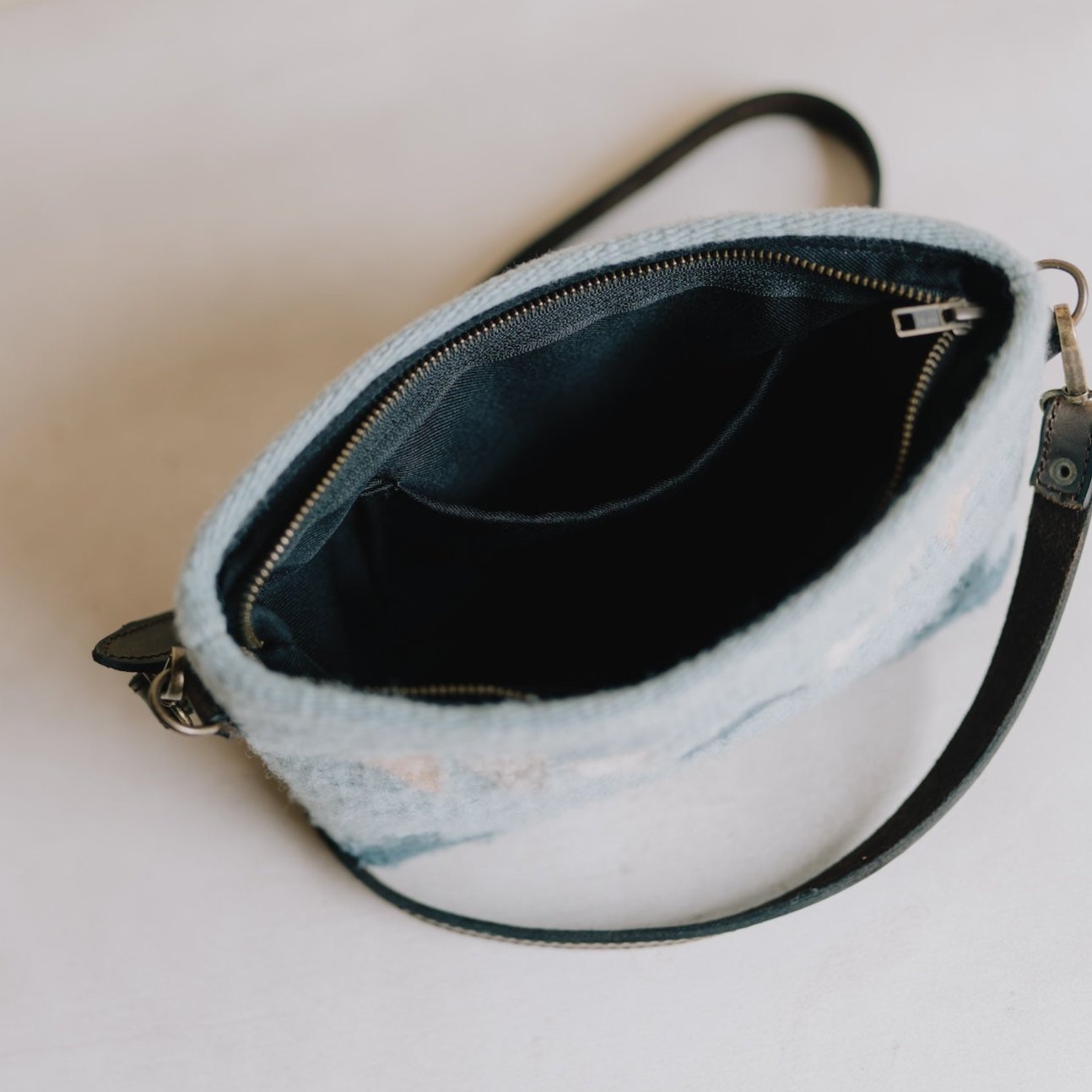 Interior view of AMASOUK handwoven wool Cielito bag with a Zapotec pattern in shades of blue. A chic and versatile 3-in-1 accessory for clutch, wristlet, or crossbody use.