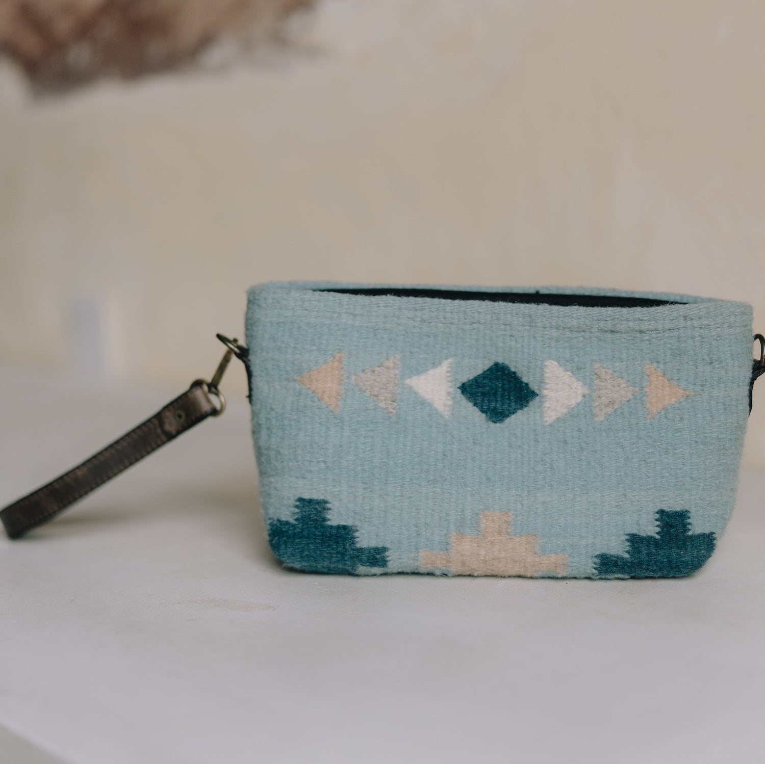 Cielito Convertible Clutch/Wristlet/Crossbody Bag by AMASOUK, showcasing a handwoven wool design with a Zapotec pattern in rich blue tones. Stylish and functional for everyday use.