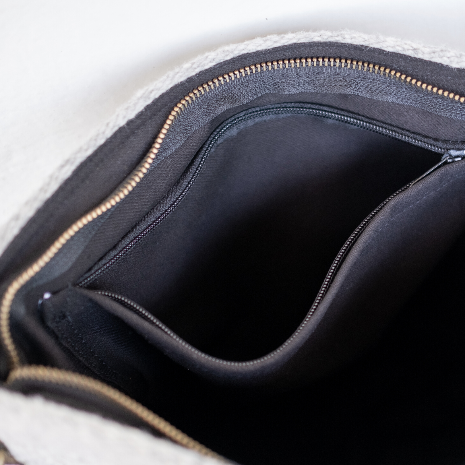 Interior view of AMASOUK handwoven wool convertible shoulder/crossbody bag in Leona pattern, adorned with a Zapotec design in muted tones of smoke, vanilla, and obsidian. Ideal for carrying essentials throughout the day.