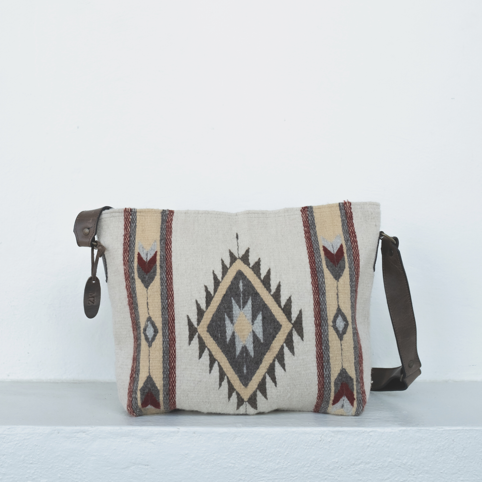 AMASOUK handwoven wool Snowflake convertible shoulder/crossbody bag in deep red, accented with soft gold and cool gray on natural cream wool. Stylish and versatile for daily use and evening outings.