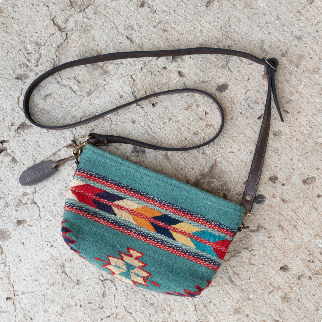 Handwoven convertible clutch with Zapotec pattern in bold colors; can be used as a pouch, wristlet, or crossbody with included leather straps and internal pocket.